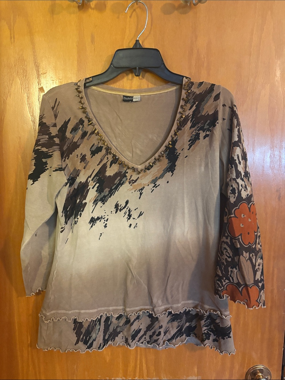 Bamboo Taupe V-Neck Long Sleeve Top with Black & Orange Accents and stone beaded